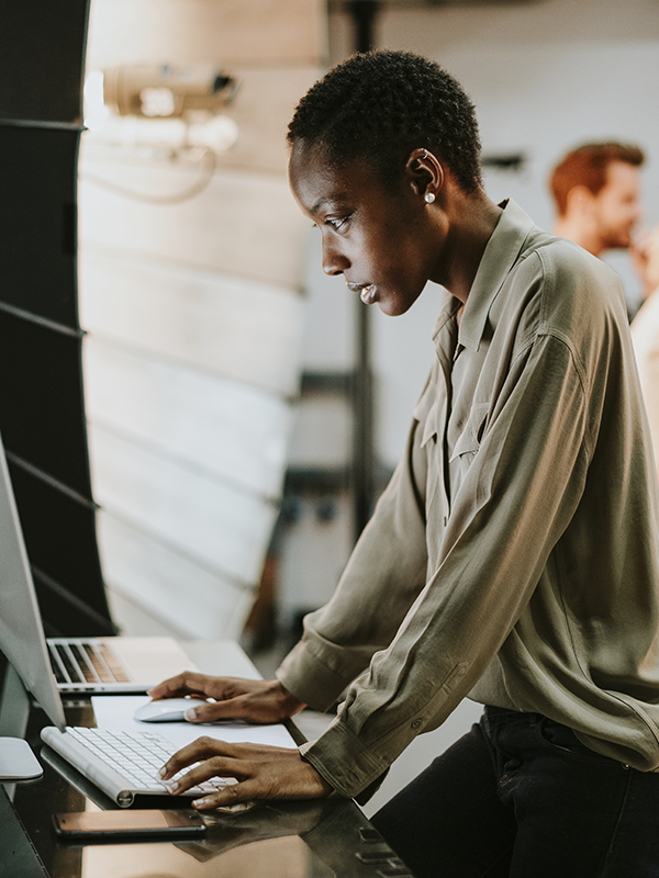 Woman on a film set looking at a computer screen. Blue Ice Africa Film and Television Production.