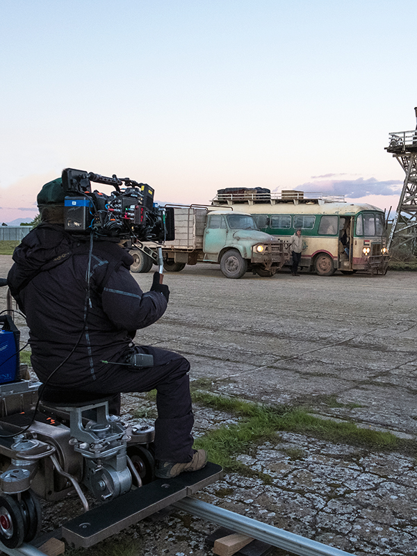 A cameraman shooting a movie scene while sitting on a dolly. Blue Ice Africa Film and Television Production.